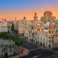 Valencia, Spain, August 19, 2018. Aerial view of the old Town Hall and its square, North Station and other historic buildings in the area, at sunset.